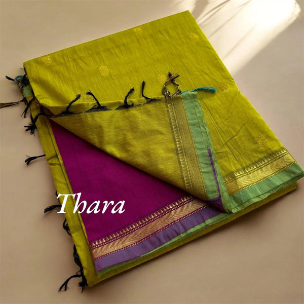 Handloom green saree with gold border, purple underside, and tassel details