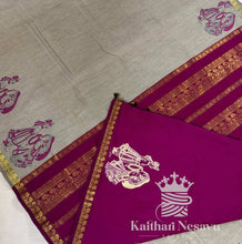 Handloom cotton saree with grey body, pink pallu, gold border, and traditional motif.