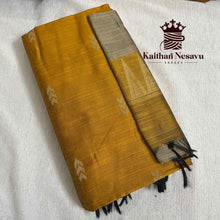 Handloom mustard yellow cotton saree with subtle motifs and black pallu detail