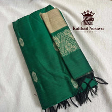 Green handloom silk saree with gold zari border and intricate woven motifs, folded on fabric background