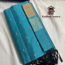 Handloom teal blue silk saree with gold zari border and black tassels, traditional Indian design
