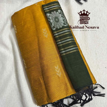 Handloom mustard yellow and green cotton saree with silver floral border on white fabric background