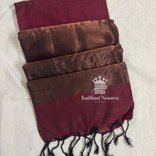 Maroon and copper handloom silk saree with tasseled edge on a light background