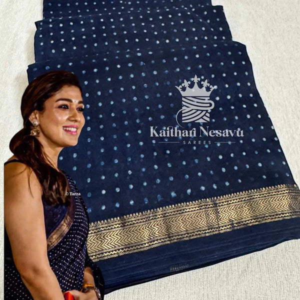 Woman in navy blue dot cotton saree with gold border, traditional handloom style