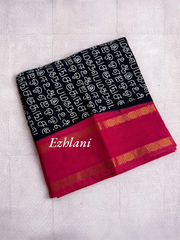 Black and red saree with a pattern on a light gray background