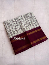 Tamil Alphabet Print Sungudi Cotton Saree - Half white Saree with maroon border.