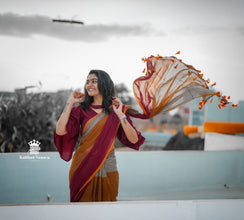 Woman in a colorful saree with a scenic background