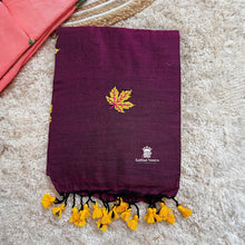 Purple saree with yellow leaf design and tassels on a beige surface
