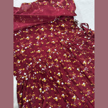 Maroon fabric with floral pattern on a white background