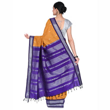 Woman wearing a purple and orange saree on a white background