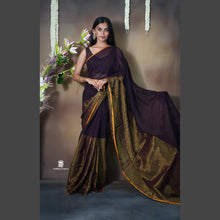 Woman wearing a traditional saree with a floral background
