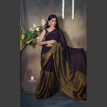 Woman wearing a traditional saree with a floral arrangement in the background