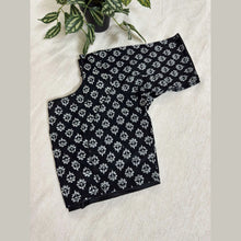 Black handloom cotton blouse with white floral print, displayed on beige fabric