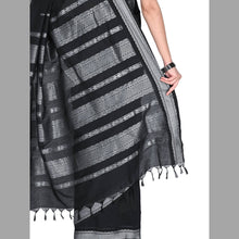 Black and gray striped scarf with tassels on a plain background