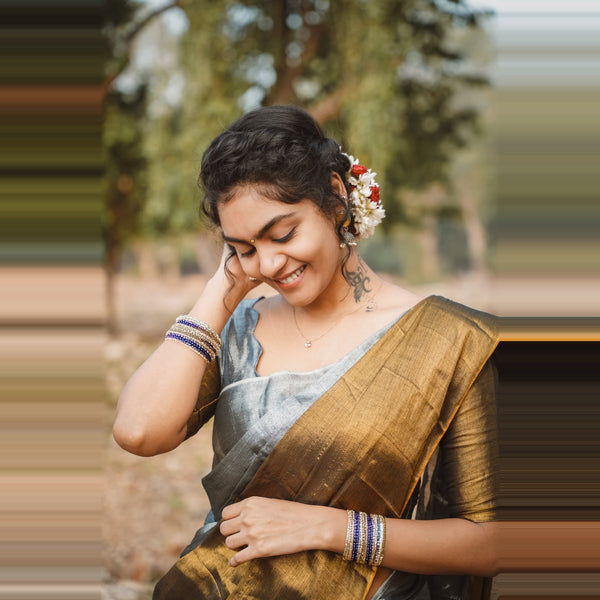Woman in traditional attire with a blurred natural background