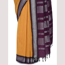 Yellow saree with a purple border on a light gray background