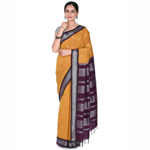 Woman wearing a yellow saree with a purple and gray border on a white background