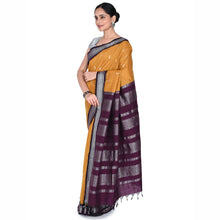 Woman wearing a yellow and purple saree with a white background