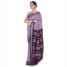 Woman wearing a purple saree with a white background