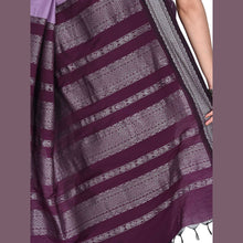 Purple and gray striped fabric with intricate patterns, held by a person.