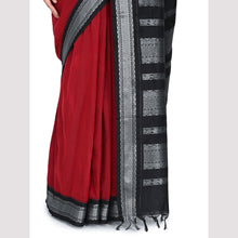 Red saree with black and silver border on a light gray background