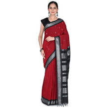 Woman wearing a red saree with black and silver border on a white background