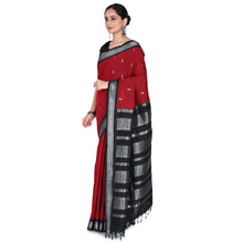 Woman wearing a red and black saree with a white background