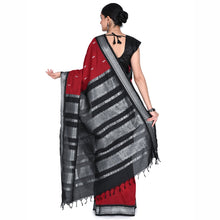 Woman wearing a black, red, and gray saree on a white background