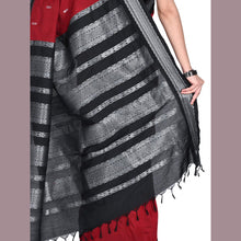 Black and gray striped scarf draped over a person wearing a red garment.