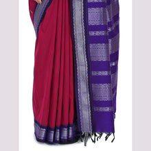Red saree with a purple border on a light gray background