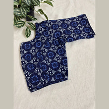 Navy blue floral print cotton blouse piece with white geometric patterns on a cream background