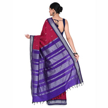 Woman wearing a purple and red saree with a white background