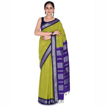 Woman wearing a green and purple saree on a white background