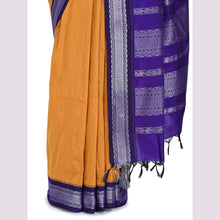 Saree with orange fabric and purple border on a light gray background